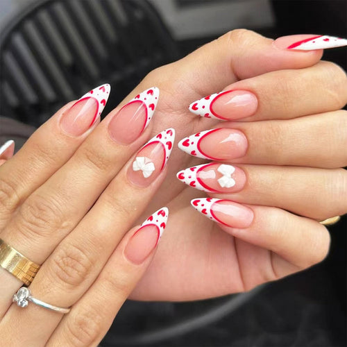 Valentines Day Press on Nails Medium Almond Fake Nails with Red Heart Bow Designs White French Tip Nails Press ons Glossy Glue on Nails Cute False Nails Nude Stick on Nails for Women 24Pcs